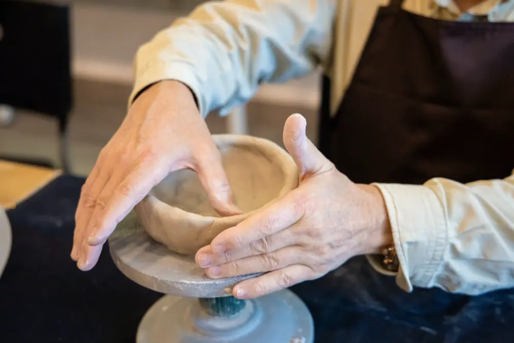 person doing pottery