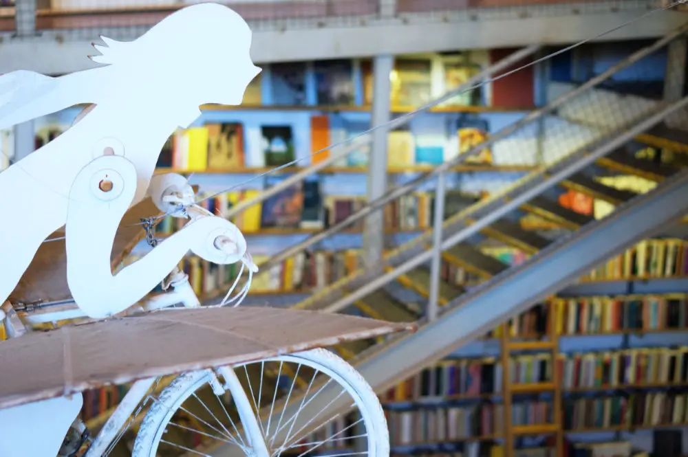 white sculpture with books on the back