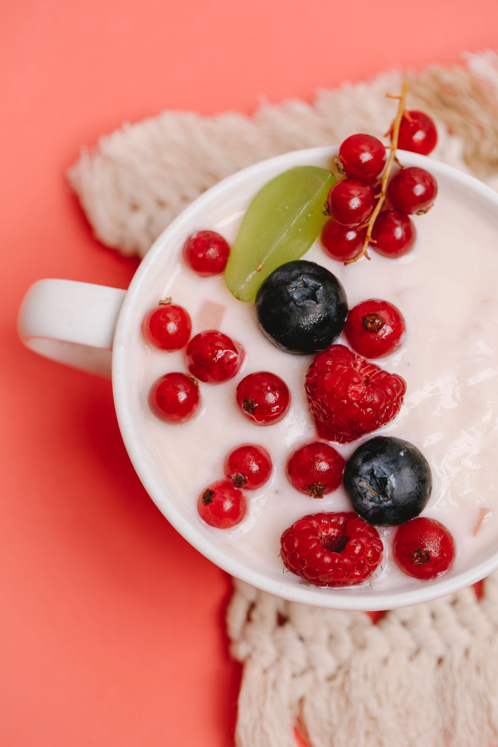 greek yogurt in a bowl with red fruits
