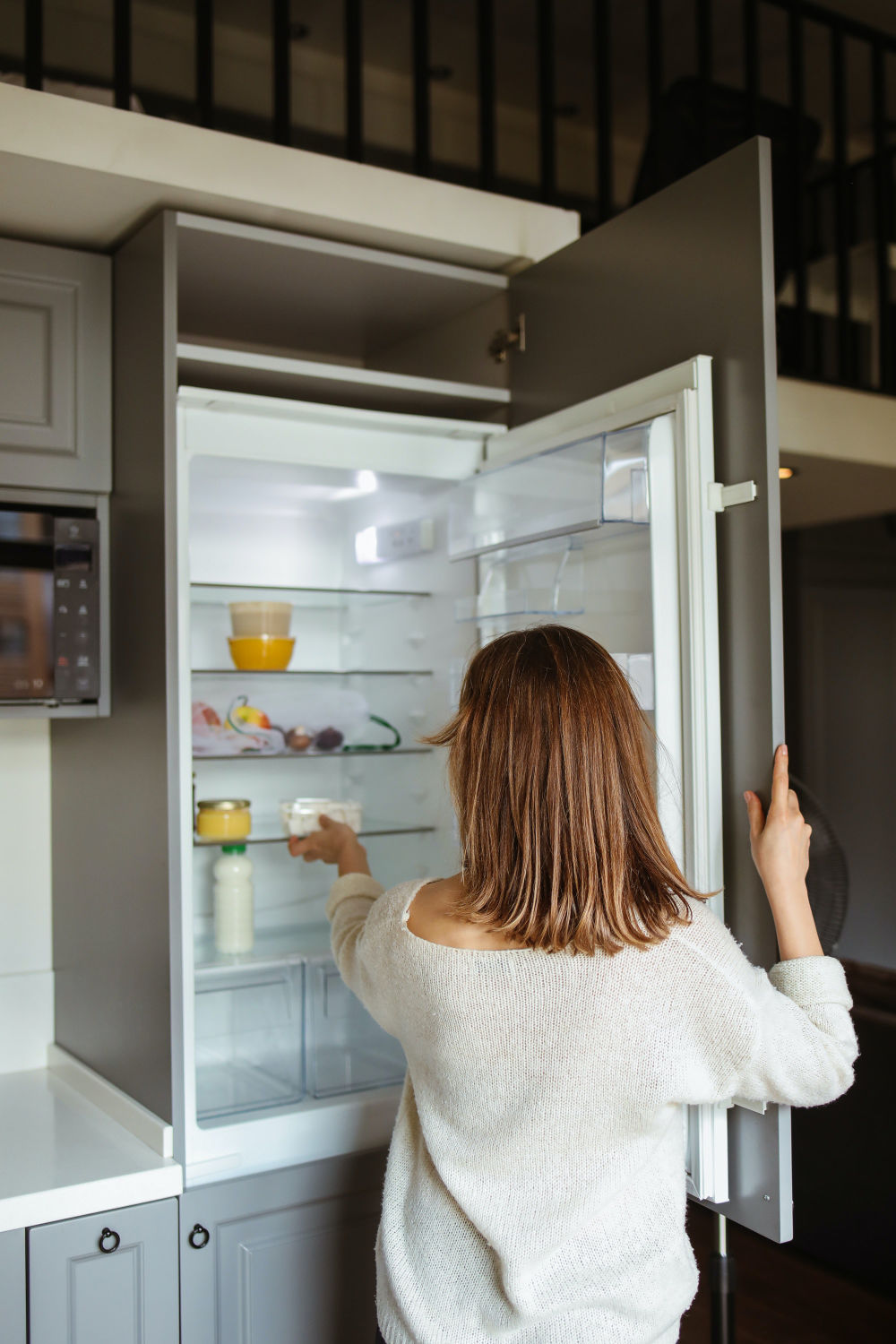 woman opening fridge